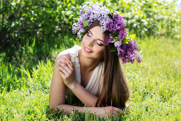Beautiful girl with a lilac flowers - Фото, изображение