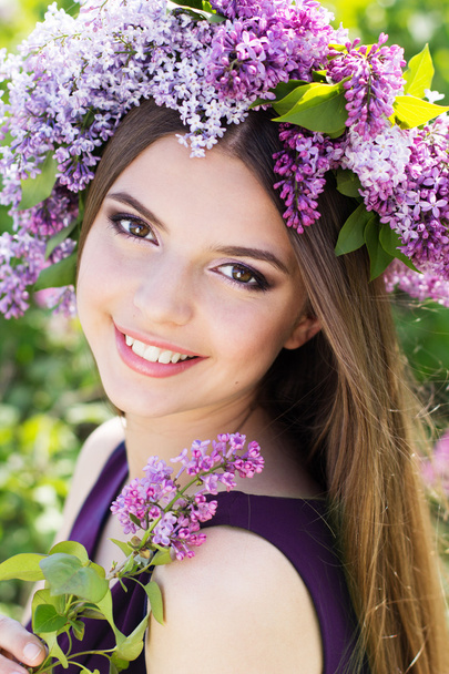 Beautiful girl with a lilac flowers - 写真・画像