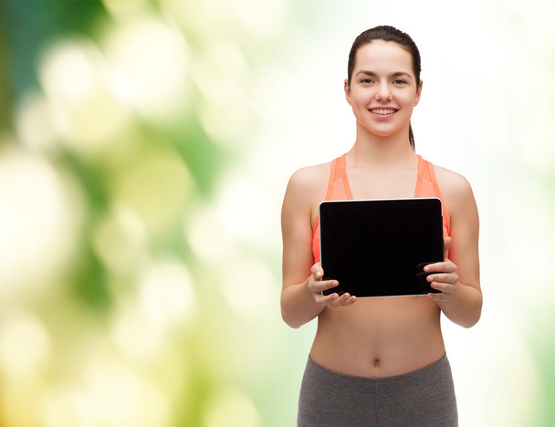 Sporty woman with tablet pc blank screen - 写真・画像