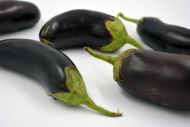 Fresh and healthy vegetables from breast, blue, purple eggplants located on a white background.  - Valokuva, kuva