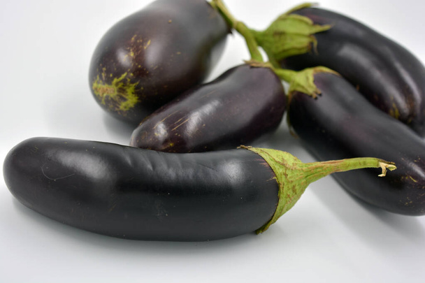Fresh and healthy vegetables from breast, blue, purple eggplants located on a white background.  - Fotografie, Obrázek