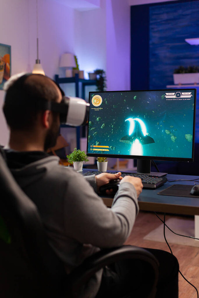 Player man playing video game at powerful computer - Photo, Image