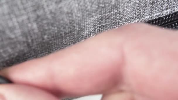 Silver luggage zipper closure with metal clasp and black plastic teeth. macro shot. - Filmmaterial, Video