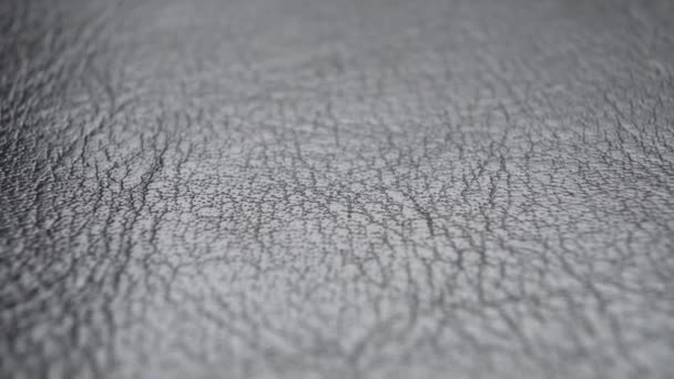 Leather black material texture. Wrinkled Abstract natural pattern. Gray upholstery fabric. Macro shot - Footage, Video
