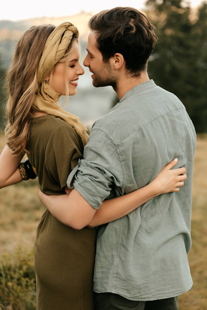 Young happy couple in love hugging smiling and having fun in the mountains. High quality photo - Photo, Image