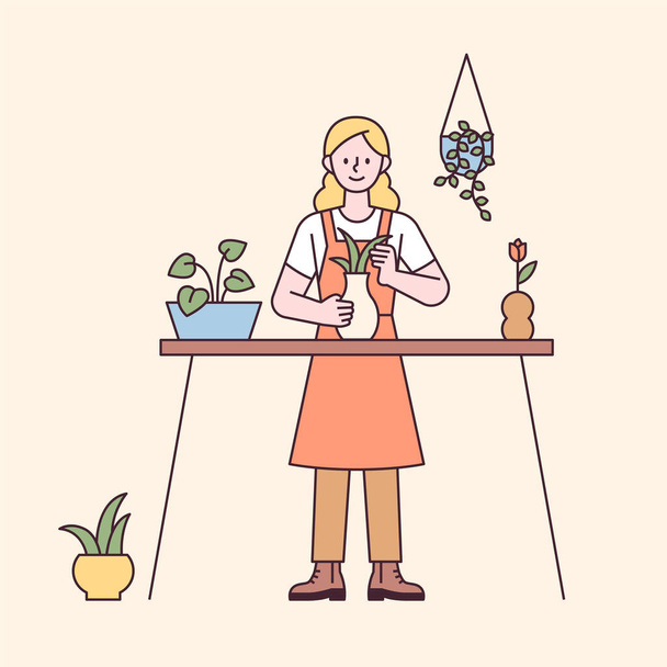 Una mujer está haciendo jardinería en casa sobre la mesa. diseño plano estilo mínima ilustración vectorial. - Vector, Imagen