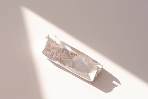 an empty chocolate bar wrapper on a white background. - Photo, Image