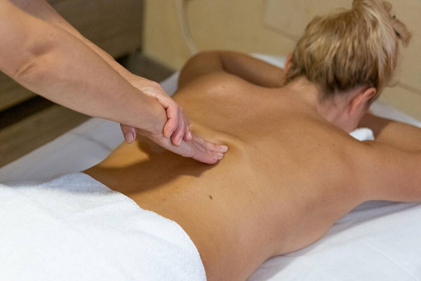 Chiromassage therapist giving a back massage to a client - Photo, Image