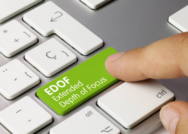 EDOF Extended Depth of Focus Written on Green Key of Metallic Keyboard. Stisknutí klávesy prstu. - Fotografie, Obrázek