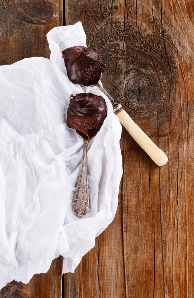 Chocolate spread on spoons on wooden background  - Photo, Image