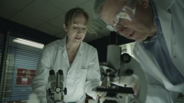 Male and female research experts working in laboratory - Materiał filmowy, wideo