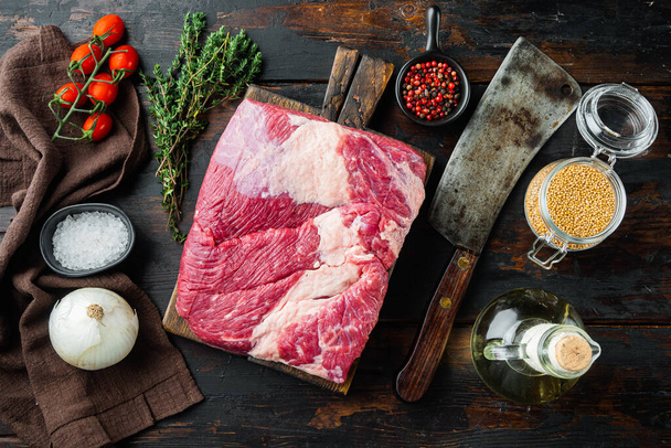 Snack cross cut, raw beef brisket meat set,with ingredients for smoking  making  barbecue, pastrami, cure, on old dark  wooden table background, top view flat lay - Photo, Image