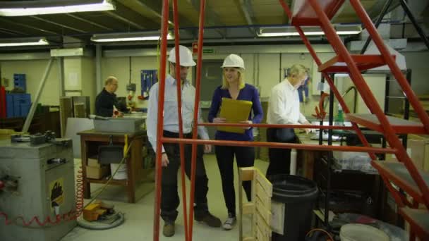 Staff members in a busy warehouse, each carrying out their own roles - Footage, Video