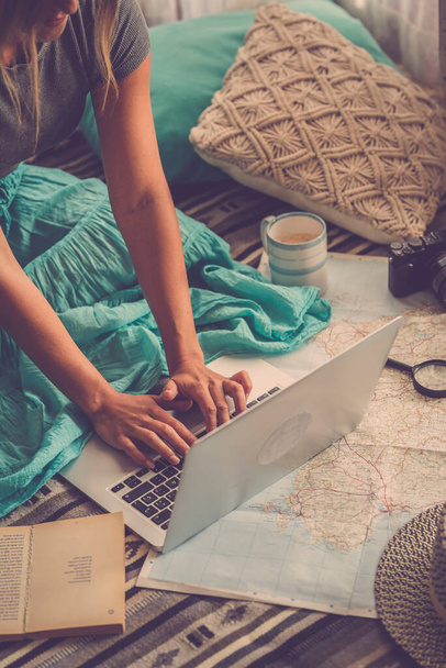 Közelkép a kaukázusi nő tervezi nyaralás utazás laptop és internet otthon, olvasás turisztikai blog online, miközben pihentető a padlón - Fotó, kép