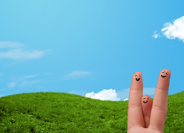 Cheerful finger smileys with landscape scenery at the background - Photo, Image