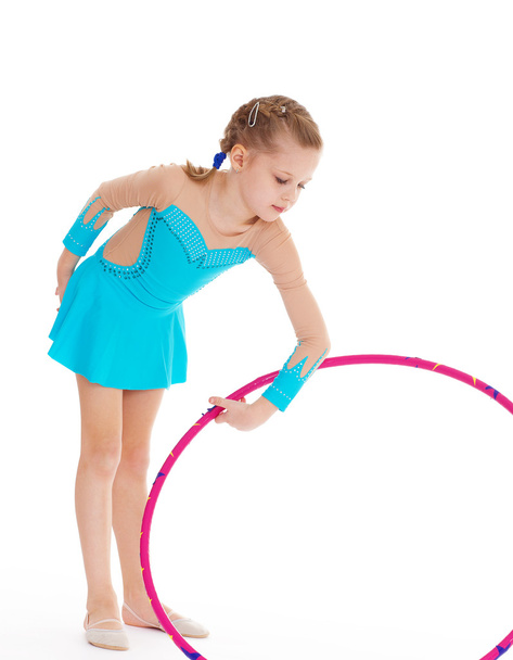 Beautiful little gymnast with the hoop - Foto, Imagen