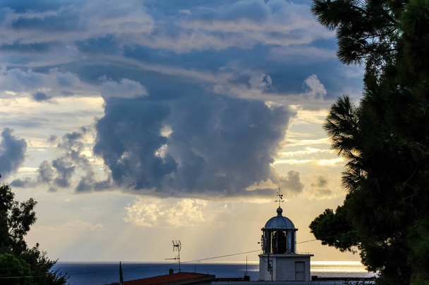 lighthouse  with cloudy sky in calabria sunset - Photo, Image