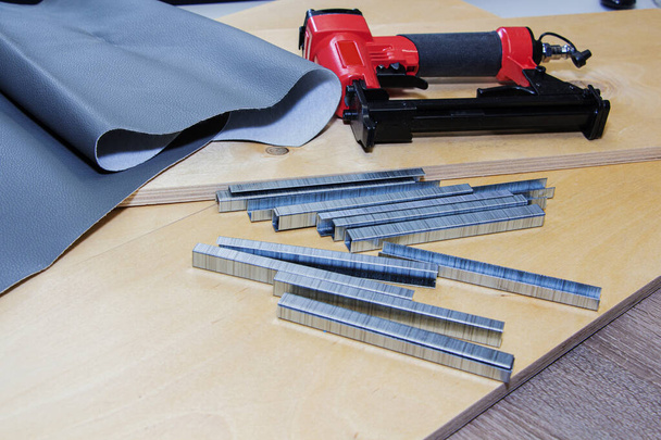 concept of furniture production and repair. Stapler and staples, working tool - Photo, Image