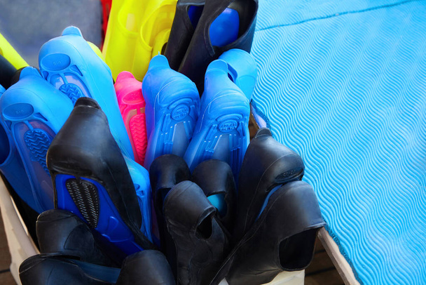 Colorful flippers in the box. Diving and snorkeling accessories - Foto, afbeelding