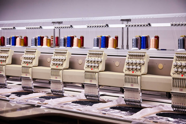 Automatic Embroidery Machines in process on the factory. 9 Needle Compact Embroidery Machine.  - Фото, изображение