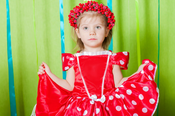 Beautiful girl in a red dress and  wreath of red berries - Фото, зображення