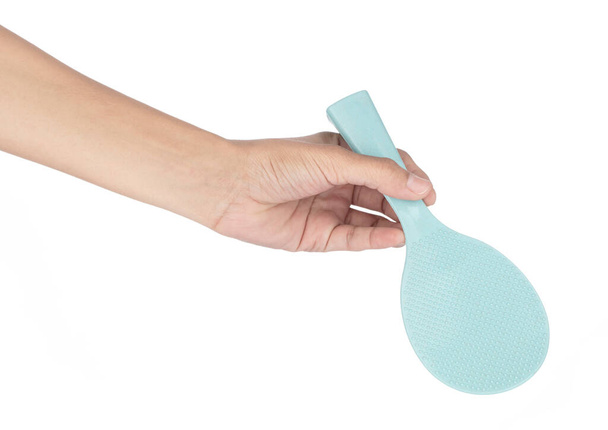 Hand holding Plastic Rice Paddle Spoon isolated on white background. - Photo, Image