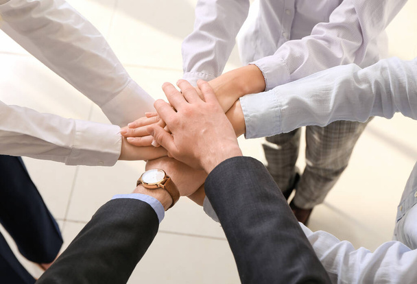 Team of business people putting hands together in office - Photo, Image
