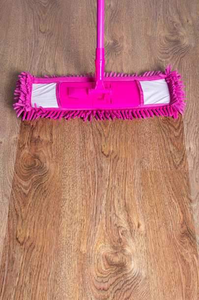 Nahaufnahme der hölzernen Parkettboden mit rosa Mop - vor nach - Foto, Bild