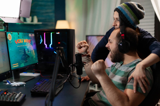 Streamer couple winning online space shooter competition - Photo, Image