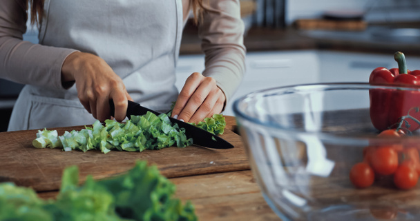 cropped view of woman cutting green lettuce on chopping board - Photo, Image