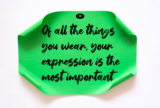 Inspirational motivational quote. Of all the things you wear, your expression is the most important. - Photo, Image
