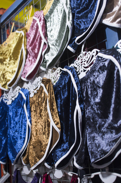 Velvet shorts of assorted colors for sale at a local flea market or boutique clothes store. - Photo, Image