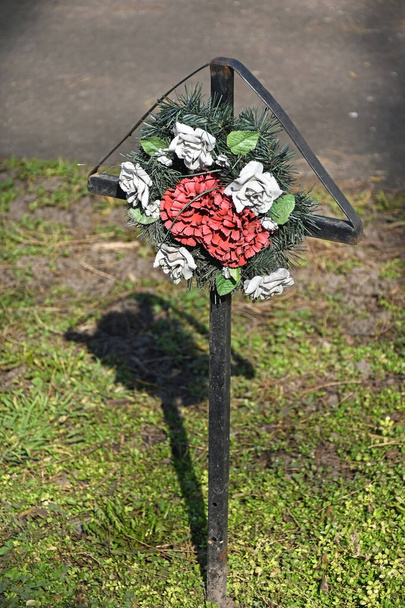 Memorial cross with flowers next to the road - Photo, Image