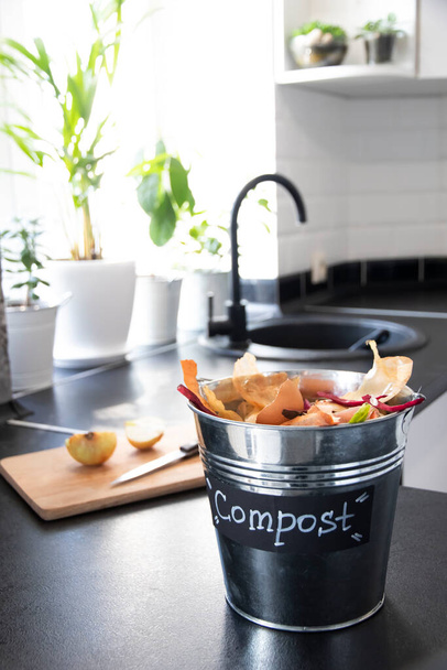 Metal bucket for composting with residue vegetables in modern light kitchen. Recycling concept. Organic. Zero-waste lifestyle. Eco-friendly home. - Photo, Image