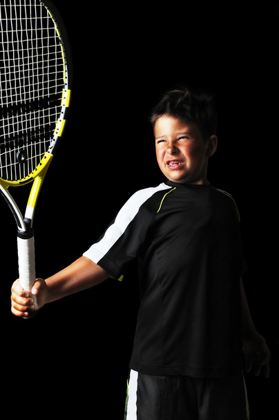 Handsome boy with tennis equipment playing backhand - Foto, immagini