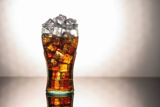 Original glass of Coca Cola with ice and Coca Cola. UK, England, March 3, 2021 - Photo, Image