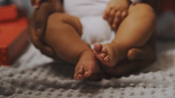 Close up, baby feet. Father and son bonding. African american man playing with little feet of his mulatto baby - Footage, Video
