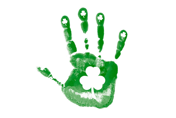 Green palm print with shamrock on a white background close up. St.Patrick 's Day. - Foto, Imagen