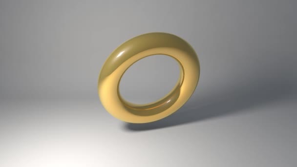 金色のプラスチック製または金属製のリングやフープは灰色の背景アニメーション3Dで回転します - 映像、動画