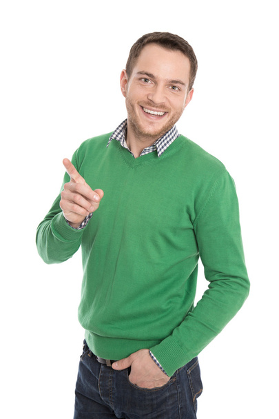 Isolated happy man in green presenting with forefinger. - Foto, immagini