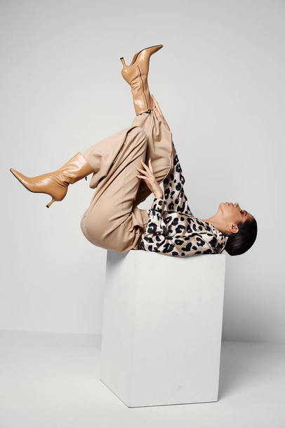 woman upside down leopard shirt cosmetics glamor - Foto, Bild