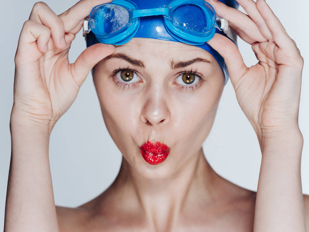Woman in blue cap diving swimming training model cropped view - Foto, Bild