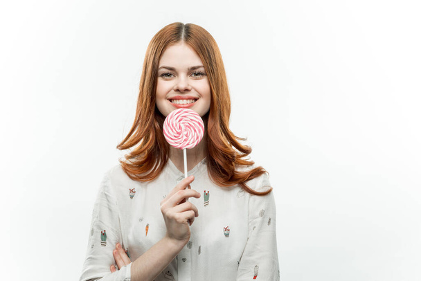 pretty woman with lollipop in hands sweets enjoyment light background - Foto, Bild