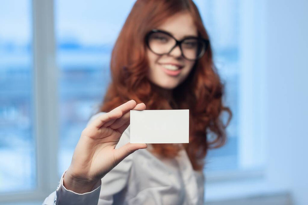 cheerful business woman holding a business card office executive financial coffee space - Fotó, kép