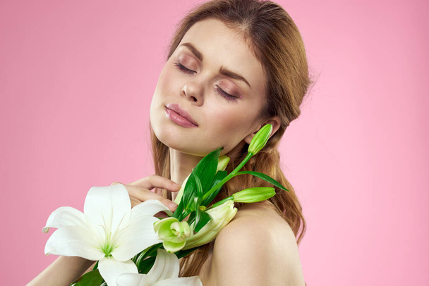 Portrait of woman with white flowers beautiful face pink background naked shoulders - Fotografie, Obrázek
