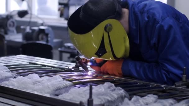 Man wearing mask welding in a workshop. Metal workers use manual labor. Skilled welder. Welder is welding the stainless steel pipes in the factory. welder Industrial part in factory. - Footage, Video