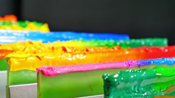Color printing for shirts on the green squeegee handle for printing shirts placing in tee shirt factory.T-shirt paints are viscous and contain oil. - Footage, Video