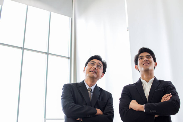 group of asia successful business people standing cross arm.Diverse business team smiling looking up  in office - Photo, Image