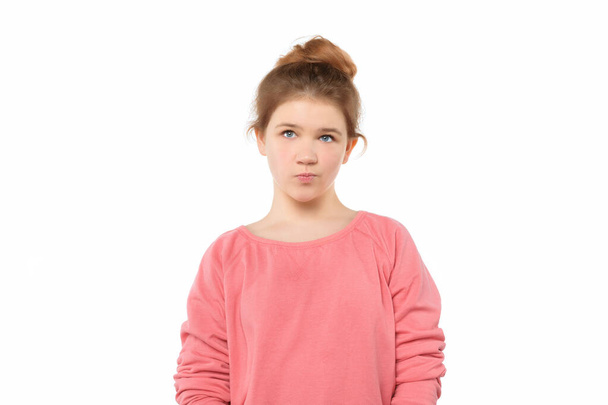 cute teen girl standing alone feeling upset, frustrated and disappointed, looking aside, thinking about something, has innocent expression - Photo, Image