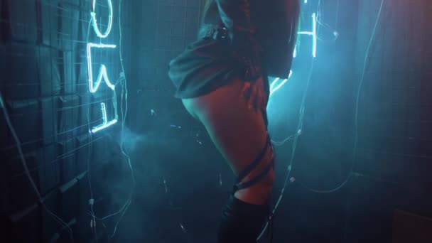 Sexy woman dancing at a night party. lift up a leather skirt and show the ass. Dance party with neon lights. - Filmati, video